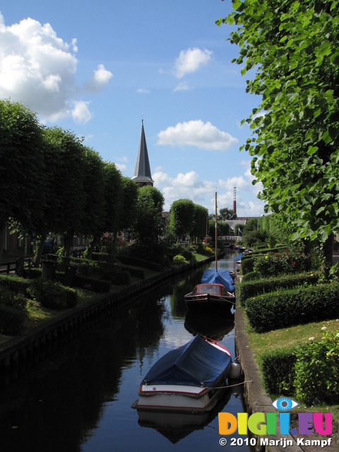 SX15188 Church spire and boats in river Ee in Ijlst